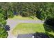 Aerial view showing a home with a large yard, mature trees, and proximity to a water feature at 4265 Hidden Valley Dr, South Fulton, GA 30349