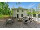 Backyard with a gravel patio, fire pit, seating, and grilling area at 4265 Hidden Valley Dr, South Fulton, GA 30349