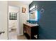 Stylist bathroom with wood vanity, granite countertop, an eye-catching blue accent wall, and modern fixtures at 4265 Hidden Valley Dr, South Fulton, GA 30349