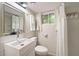 Bright bathroom featuring modern fixtures, a vanity with a sleek sink, and a shower with white curtains at 4265 Hidden Valley Dr, South Fulton, GA 30349