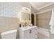 Chic bathroom featuring modern vanity, an LED mirror, decorative wallpaper, and a tub-shower combination at 4265 Hidden Valley Dr, South Fulton, GA 30349