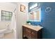 Bathroom showcasing blue accent wall, wood vanity, granite countertop, an LED mirror, and modern fixtures at 4265 Hidden Valley Dr, South Fulton, GA 30349