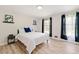 Bright bedroom featuring wood-look flooring, white walls, and lots of natural light from the window at 4265 Hidden Valley Dr, South Fulton, GA 30349