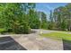 Long driveway leads to a property surrounded by lush greenery, showcasing the property's privacy at 4265 Hidden Valley Dr, South Fulton, GA 30349