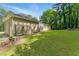 Lush green yard with mature trees surrounding the home, including a garden feature and exterior structure at 4265 Hidden Valley Dr, South Fulton, GA 30349