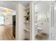 Hallway featuring shelves, leading to a well-lit bathroom with modern fixtures at 4265 Hidden Valley Dr, South Fulton, GA 30349