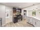 Open kitchen with stainless appliances, marble counters, and light-filled breakfast bar at 4265 Hidden Valley Dr, South Fulton, GA 30349