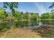 Picturesque pond reflecting the surrounding trees and sky, enhancing the property's natural beauty at 4265 Hidden Valley Dr, South Fulton, GA 30349