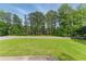 Expansive green property with tall trees surrounding it, promising privacy and scenic views at 4265 Hidden Valley Dr, South Fulton, GA 30349