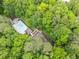 Aerial view showcases community pool nestled amongst mature trees and landscaping at 4365 Dover Crossing Dr, Marietta, GA 30066