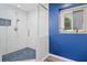 Modern bathroom with blue accent wall, glass-enclosed shower, and hexagon tile floor at 4365 Dover Crossing Dr, Marietta, GA 30066