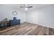 Bright bedroom with blue accent furniture, ceiling fan, and wood-look flooring at 4365 Dover Crossing Dr, Marietta, GA 30066