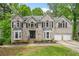 Charming two-story brick home with a landscaped front yard and two-car garage at 4365 Dover Crossing Dr, Marietta, GA 30066