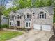 Beautiful two-story brick home with attached two-car garage, bay windows, and professionally landscaped yard at 4365 Dover Crossing Dr, Marietta, GA 30066