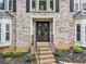 Welcoming brick home entrance with unique front door and manicured landscaping at 4365 Dover Crossing Dr, Marietta, GA 30066