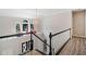Elegant hallway featuring wood-look floors, natural light, and black and white railing leading to downstairs at 4365 Dover Crossing Dr, Marietta, GA 30066