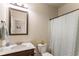 The bathroom has a vanity with white marble and dark cabinets, a decorative mirror, and a shower with curtain at 6280 Stillwood Ln, Cumming, GA 30041