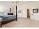 A carpeted bedroom featuring a four-poster bed with ensuite bathroom and walk-in closets at 6280 Stillwood Ln, Cumming, GA 30041