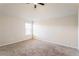 Empty bedroom with carpeted floors and natural light from a bright window at 6280 Stillwood Ln, Cumming, GA 30041