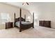 A spacious bedroom featuring a four-poster bed, vaulted ceiling, and natural light from two windows at 6280 Stillwood Ln, Cumming, GA 30041