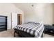 Carpeted bedroom with vaulted ceiling, including a bookcase and black side table at 6280 Stillwood Ln, Cumming, GA 30041