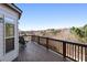 A lovely deck with wood flooring and rails offers stunning views of the surrounding trees and community at 6280 Stillwood Ln, Cumming, GA 30041