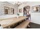 Charming dining area with wainscoting, brick accent wall, and rustic wooden table at 6280 Stillwood Ln, Cumming, GA 30041