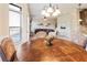 Inviting dining area with a wooden table set near a window, showcasing the open-concept design to the living spaces at 6280 Stillwood Ln, Cumming, GA 30041