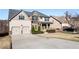Charming two-story home with a manicured lawn, a long driveway, and a two-car garage at 6280 Stillwood Ln, Cumming, GA 30041