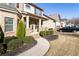 Inviting two-story home showcasing brick facade, manicured lawn, and a charming covered front porch with decorative columns at 6280 Stillwood Ln, Cumming, GA 30041