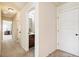 Hallway showcasing doors, leading to a bathroom, with carpeted floors, and neutral paint at 6280 Stillwood Ln, Cumming, GA 30041