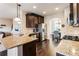 Well-appointed kitchen featuring granite countertops, dark wood cabinets, stainless steel appliances, and hardwood floors at 6280 Stillwood Ln, Cumming, GA 30041