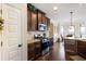 Well-equipped kitchen featuring dark wood cabinetry, stainless steel appliances, granite countertops, and views of the breakfast area at 6280 Stillwood Ln, Cumming, GA 30041