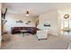 Cozy living room with a stone fireplace, carpeted floors, and staircase to the second floor at 6280 Stillwood Ln, Cumming, GA 30041