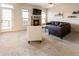 Bright living room with a fireplace, carpeted floors, and access to the backyard at 6280 Stillwood Ln, Cumming, GA 30041