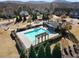 Aerial view of a community pool featuring lounge seating and pergola surrounded by lush landscaping at 6280 Stillwood Ln, Cumming, GA 30041