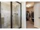 Bathroom shower showcasing tile walls, a built-in seat, and glass door with adjacent walk-in closet at 6280 Stillwood Ln, Cumming, GA 30041