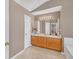 Bathroom features a double sink vanity, tile floors, and bright lighting at 1332 Kent Mnr, Stockbridge, GA 30281
