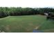 View of expansive green community park and play area surrounded by lush trees and landscaping at 1332 Kent Mnr, Stockbridge, GA 30281