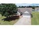 Charming one-story home featuring a well-manicured lawn and a two-car garage at 1332 Kent Mnr, Stockbridge, GA 30281