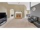 Cozy living room featuring a stone fireplace and access to the dining area at 1332 Kent Mnr, Stockbridge, GA 30281