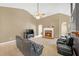 A spacious living room with a fireplace, a ceiling fan, and comfortable seating at 1332 Kent Mnr, Stockbridge, GA 30281