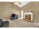 Comfortable living room featuring a fireplace with brick surround, neutral paint and carpet at 1332 Kent Mnr, Stockbridge, GA 30281