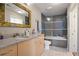 Stylish bathroom with granite countertops, vanity, and a shower-tub combination with glass doors at 860 Peachtree Ne St # 904, Atlanta, GA 30308