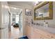 Well-lit bathroom featuring a granite countertop vanity and a decorative mirror at 860 Peachtree Ne St # 904, Atlanta, GA 30308
