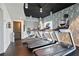 Treadmills line a wall with modern wallpaper and a window in the community gym at 860 Peachtree Ne St # 904, Atlanta, GA 30308