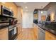 Well-lit kitchen with stainless steel appliances, stylish tile backsplash, and wood cabinets at 860 Peachtree Ne St # 904, Atlanta, GA 30308