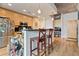 Open kitchen with breakfast bar, modern appliances, wood cabinets, and concrete ceiling at 860 Peachtree Ne St # 904, Atlanta, GA 30308