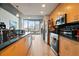 Modern kitchen featuring wood cabinets, stainless steel appliances, and black backsplash at 860 Peachtree Ne St # 904, Atlanta, GA 30308
