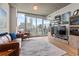 Bright living room with hardwood floors, city views, and a comfortable leather sofa and armchairs at 860 Peachtree Ne St # 904, Atlanta, GA 30308